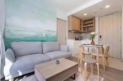 a living room with a couch and a table at SkyPark , Bangtao , Apartment near beach 2 bedroom in Bang Tao Beach