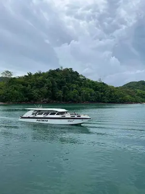 a white boat in the water on a river at Baansuanpiyanan in Ban Bang Chak
