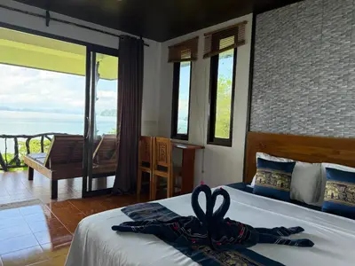 a bedroom with a bed with a towel on it at Phu Samut in Ban Ba Kan Pa