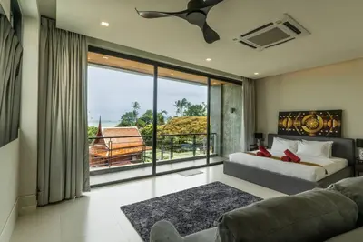 a living room with a bed and a large window at Attractive SeaView 4br Private Pool Villa in Rawai Beach