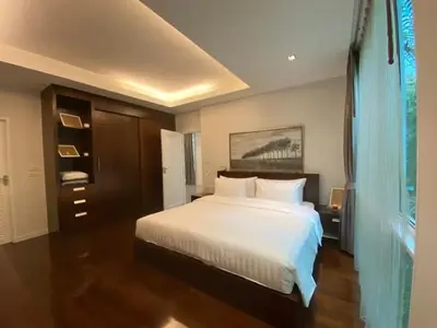 a bedroom with a large white bed and a window at Tropical 1bedroom Apartment in Kamala Beach
