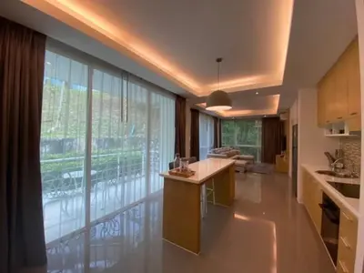 a kitchen with a large window and a kitchen island at Tropical 1bedroom Apartment in Kamala Beach
