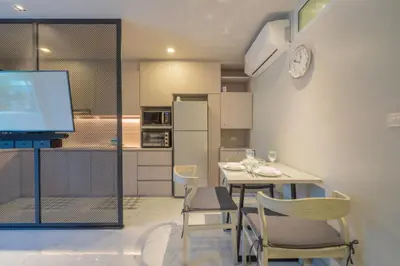 a kitchen with a table and chairs and a television at Woodbridge Property at Karon Butterfly in Karon Beach