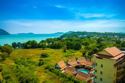 an aerial view of a building with a resort at Kana Hotel Phuket\u666e\u5409\u5c9b\u5361\u5a1c\u9152\u5e97 in Rawai Beach