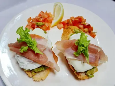 a white plate with a sandwich with meat and vegetables at Lo Sfizio in Patong Beach