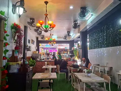 a restaurant with people sitting at tables in a room at Lo Sfizio in Patong Beach