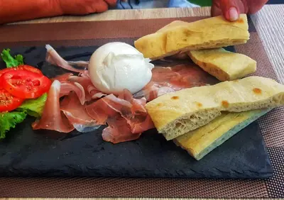 a plate of food with a sandwich and other foods at Lo Sfizio in Patong Beach