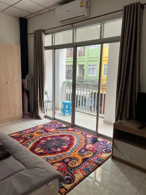 a room with a rug on the floor next to a glass door at Lo Sfizio in Patong Beach
