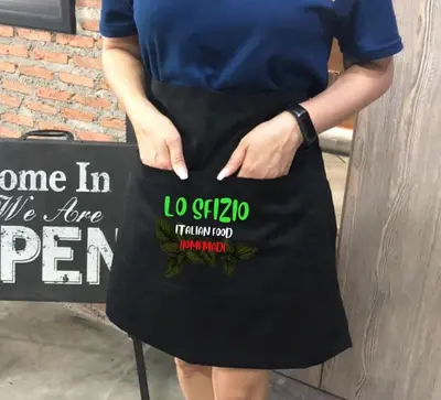 a woman in a black apron holding a sign at Lo Sfizio in Patong Beach