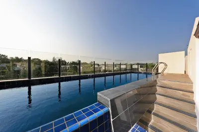 a swimming pool with blue water in a building at Laguna Park Grand Villa na Bang Tao in Phuket Town