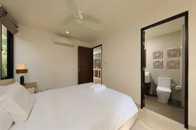 a bedroom with a white bed and a bathroom at Laguna Park Grand Villa na Bang Tao in Phuket Town