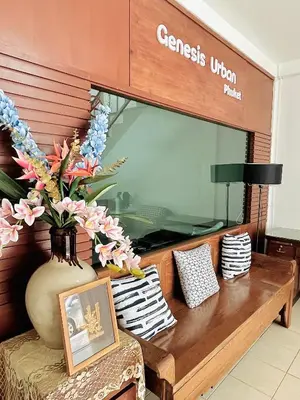 a store window with a table and a vase with flowers at Genesis Urban Phuket in Ban Lo Long