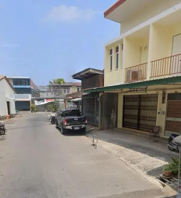 a truck parked on a street next to a building at Genesis Urban Phuket in Ban Lo Long