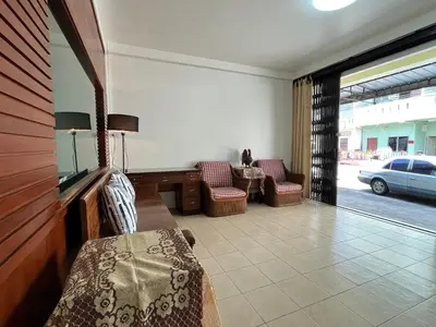a living room with a couch and chairs and a car at Genesis Urban Phuket in Ban Lo Long