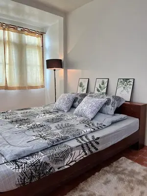 a large bed in a bedroom with a window at Genesis Urban Phuket in Ban Lo Long