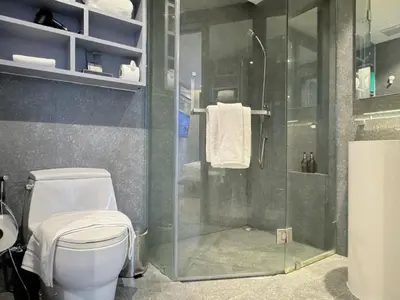 a bathroom with a toilet and a glass shower at Citygate Peaceful Condo Kamala Beach in Kamala Beach