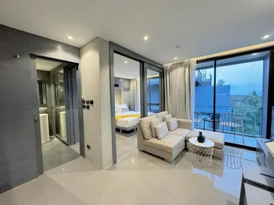 a living room with a couch and a bedroom at Citygate Peaceful Condo Kamala Beach in Kamala Beach
