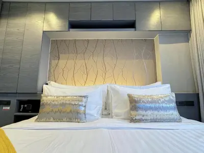 a white bed with two pillows and a headboard at Citygate Peaceful Condo Kamala Beach in Kamala Beach