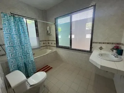 a bathroom with a toilet and a tub and a sink at Kata Sea Blue Villa in Kata Beach