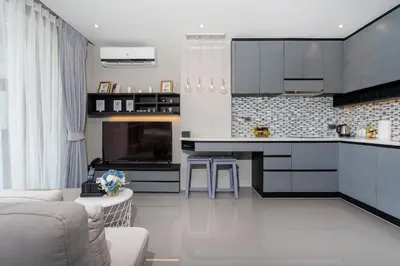 a kitchen with a couch and a counter top at Tropics Kamala Hill View Suite CTG P614, near Beach and Fantasea in Kamala Beach