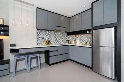 a kitchen with black and white cabinets and appliances at Tropics Kamala Hill View Suite CTG P614, near Beach and Fantasea in Kamala Beach