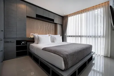 a bedroom with a large bed and a window at tropics Kamala CTG L604, near FantaSea & Café Del Mar Beach Club in Kamala Beach