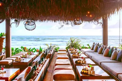 a restaurant with tables with the ocean in the background at tropics Kamala CTG L604, near FantaSea & Café Del Mar Beach Club in Kamala Beach