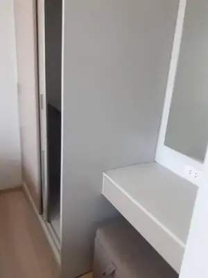 a white cabinet in a room with a mirror at Zcape 4U in Ban Thalat Choeng Thale