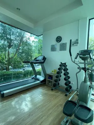 a gym with two exercise bikes and a window at Zcape 4U in Ban Thalat Choeng Thale