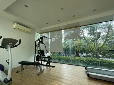 a room with a gym with a treadmill and a large window at Zcape 4U in Ban Thalat Choeng Thale