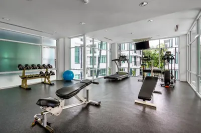 a gym with treadmills and exercise equipment in a building at \u3010\u8d85\u503c\u30112\u5367\u5ba4\u522b\u5885\u3010\u5bbd\u655e\u8212\u9002\u301113\u7c73\u957f\u79c1\u5bb6\u6cf3\u6c60\uff0c\u914d\u5957\u9f50\u5168\u51fa\u884c\u65b9\u4fbf\uff0c\u6b65\u884c700\u7c73\u5230kamala\u6d77\u6ee9 V03 in Kamala Beach