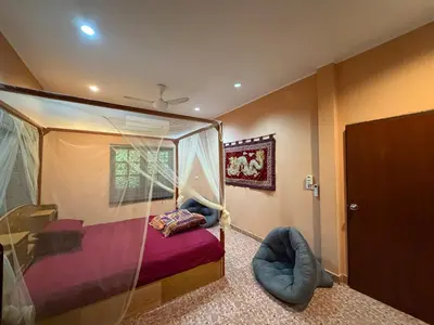 a bedroom with a bed with a glass canopy at Beachfront bungalow south of Phuket in Phuket Town