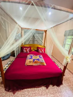 a bedroom with a bed in a tent at Beachfront bungalow south of Phuket in Phuket Town