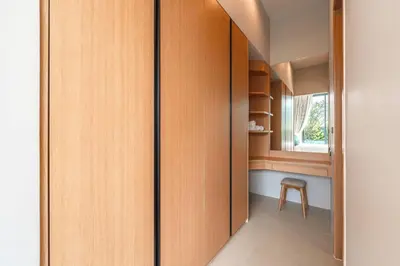 a hallway with wooden cabinets and a chair in a room at New 3BR Pool Villa Long One A5 with Chalong Bay view in Chalong