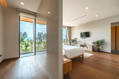 a bedroom with a bed and a large window at New 3BR Pool Villa Long One A5 with Chalong Bay view in Chalong