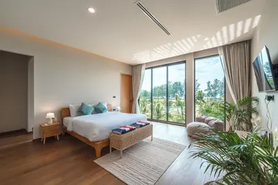 a bedroom with a bed and a large window at New 3BR Pool Villa Long One A5 with Chalong Bay view in Chalong