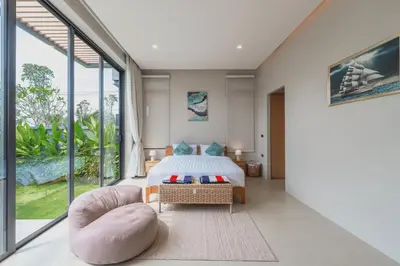 a bedroom with a bed and a large window at New 3BR Pool Villa Long One A5 with Chalong Bay view in Chalong