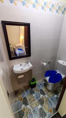 a bathroom with a sink and a mirror and a toilet at Kata Lina guesthouse in Kata Beach