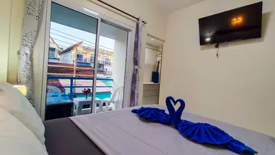 a bedroom with a bed and a window with a view at Kata Lina guesthouse in Kata Beach