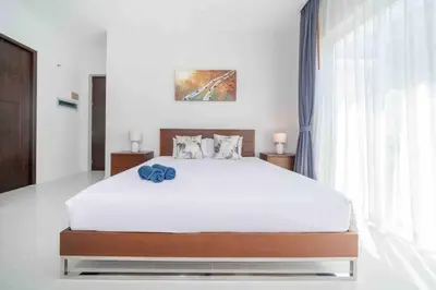a bedroom with a large bed and a large window at Modern Villa , 2-bedroom, Rawai in Ban Saiyuan (1)