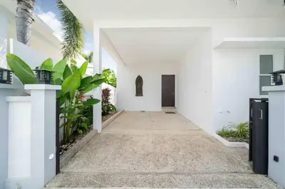 a hallway of a white house with plants at Modern Villa , 2-bedroom, Rawai in Ban Saiyuan (1)