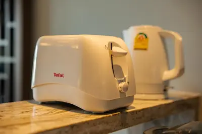 a white toaster sitting on top of a counter at ANGSANA Oceanview Apartments with a privat pool in Laguna area in Bang Tao Beach