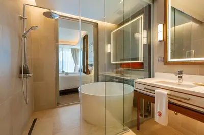 a bathroom with a shower and a sink and a tub at ANGSANA Oceanview Apartments with a privat pool in Laguna area in Bang Tao Beach
