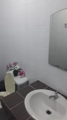 a bathroom with a white sink and a toilet at the three pyramids in Rawai Beach