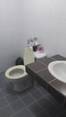 a bathroom with a toilet and a sink at the three pyramids in Rawai Beach