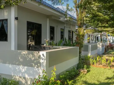 a house with a fence in front of it at Isara Nai Yang resort in Nai Yang Beach