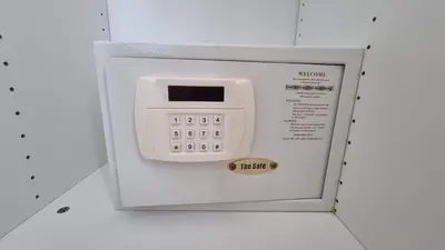 a microwave with a digital clock in a box at Bright Apartment Close to Amazing Beach ! 39 Sqm in Nai Yang Beach