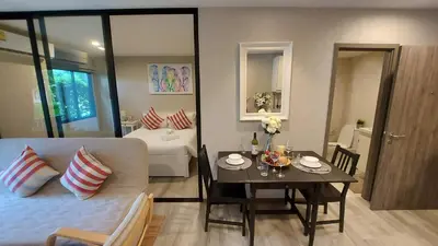 a living room with a couch and a table at Bright Apartment Close to Amazing Beach ! 39 Sqm in Nai Yang Beach