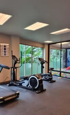 a gym with two exercise bikes in a room at Apartment Karon 62 sq in Karon Beach