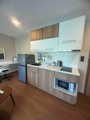 a kitchen with a microwave and a refrigerator at Title V in Rawai Beach
